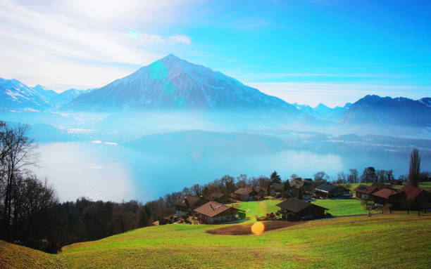 Sigrilwil village and Swiss Alps and Thun lake Sigrilwil village and Swiss Alps mountains and Thun lake, canton Bern, Switzerland in winter thun interlaken winter switzerland stock pictures, royalty-free photos & images