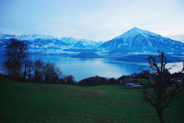 Sigrilwil village at Swiss Alps and Thun lake Sigrilwil village at Swiss Alps mountains and Thun lake, canton Bern, Switzerland in winter thun interlaken winter switzerland stock pictures, royalty-free photos & images