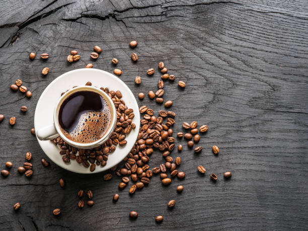 istock Cup of coffee surrounded by coffee beans. 916975712