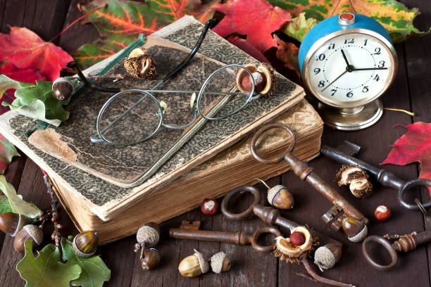 istock Autumn still life with alarm clock and  retro book 916975768