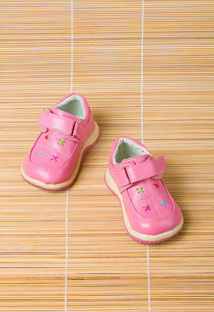 istock Pink children's shoes on bamboo 91697582