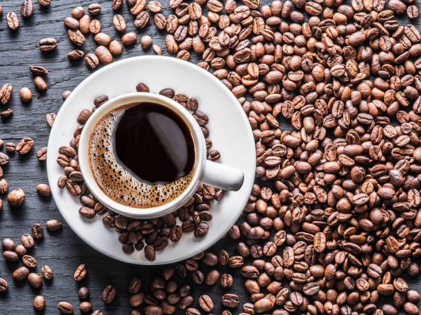 istock Cup of coffee surrounded by coffee beans. 916975918