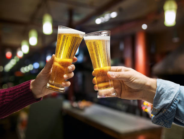istock Beer glasses raised in a toast. 916978768