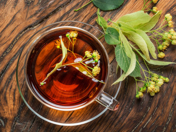 istock Cup of linden tea and lime flowers. 916979364