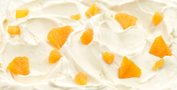 istock whipped cream with fresh orange pieces 916981836