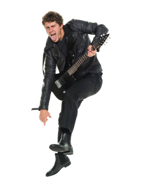 istock Attractive man playing electric guitar jumping 916985440
