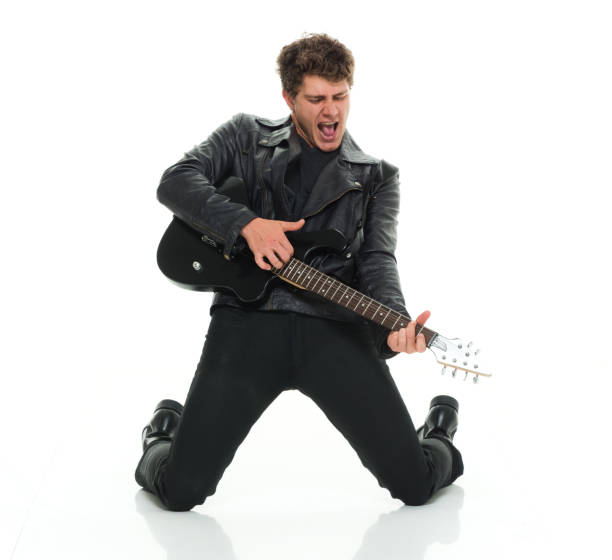 istock Attractive man playing electric guitar rocking out 916985618