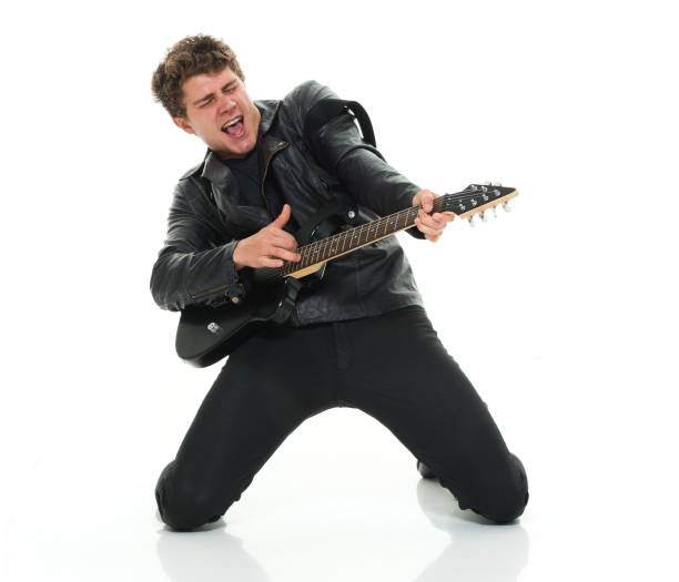 istock Attractive man playing electric guitar rocking out 916985620