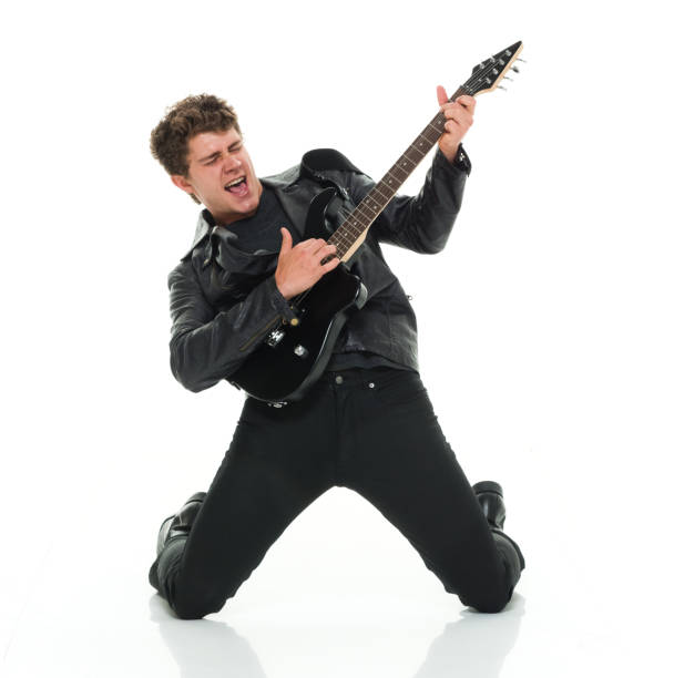 istock Attractive man playing electric guitar rocking out 916985622