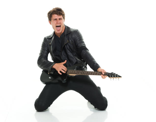 istock Attractive man playing electric guitar rocking out 916985626
