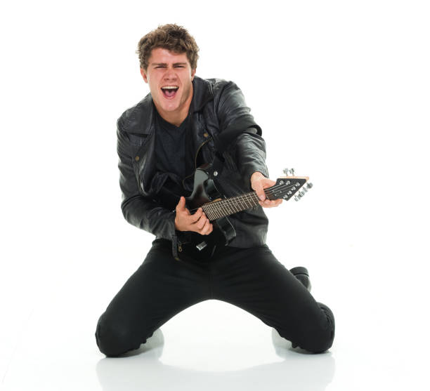 istock Attractive man playing electric guitar rocking out 916985642