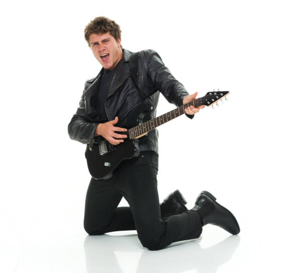 istock Attractive man playing electric guitar rocking out 916985754