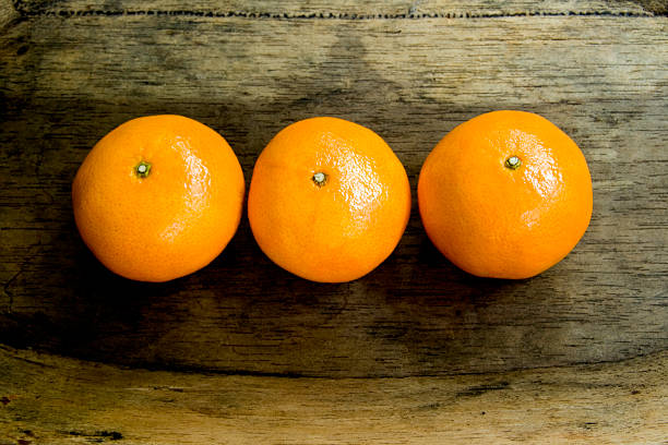 Three tangerines aligned stock photo