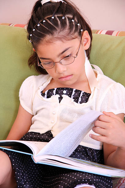 istock Little girl reading a book 91699396