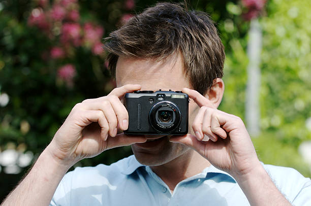 istock Casual man taking a photo with digital camera 91699461