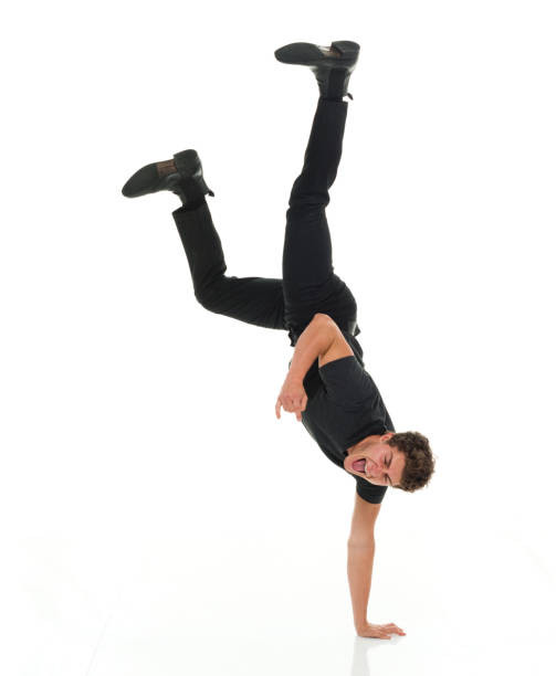 istock Attractive man in all black clothing doing hand stands 916994928