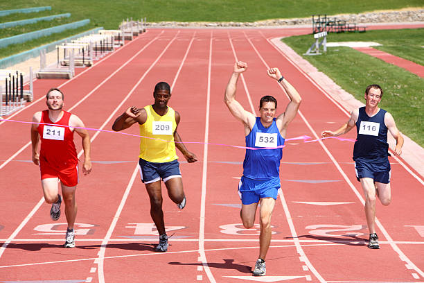 istock Four runners cross the finish line 91699668