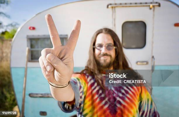 Man In Front Of Trailer Making A Peace Sign Stock Photo - Download Image Now - Hippie, Symbols Of Peace, Peace Sign - Gesture
