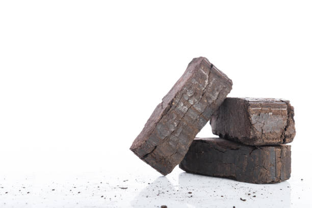 istock Peat briquettes on white background, alternative fuels, space for text 916998048