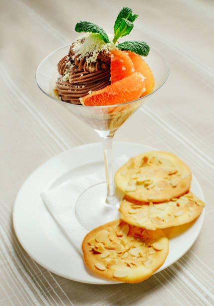 istock chocolate dessert with a greyfruit cookies and mint in a refined serve, cozy light table setting, restaurant serve 917000700