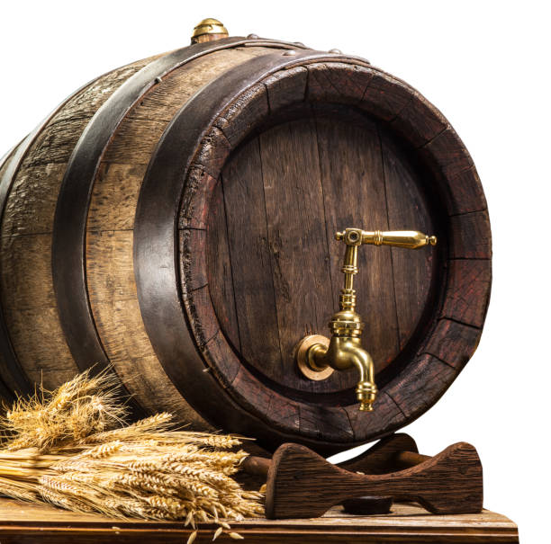 Beer barrel with bunch of wheat on the wooden table. Clipping path.