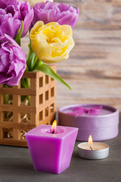 istock Purple yellow tulip flower, lit candles 917003676