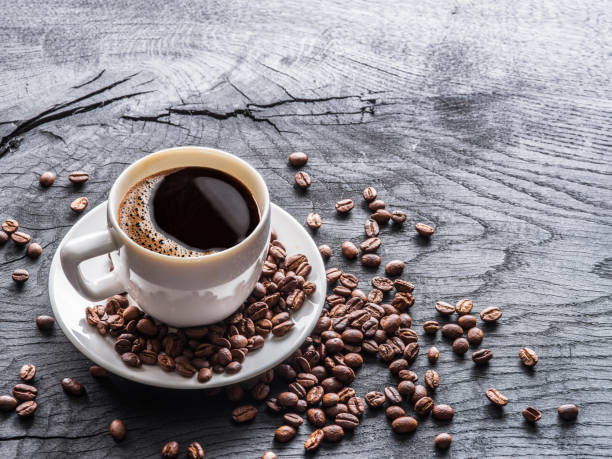 istock Cup of coffee surrounded by coffee beans. 917004150