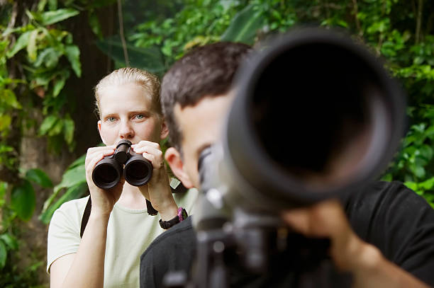 istock Pretty Woman and Man with Scopes in Jungle 91700948