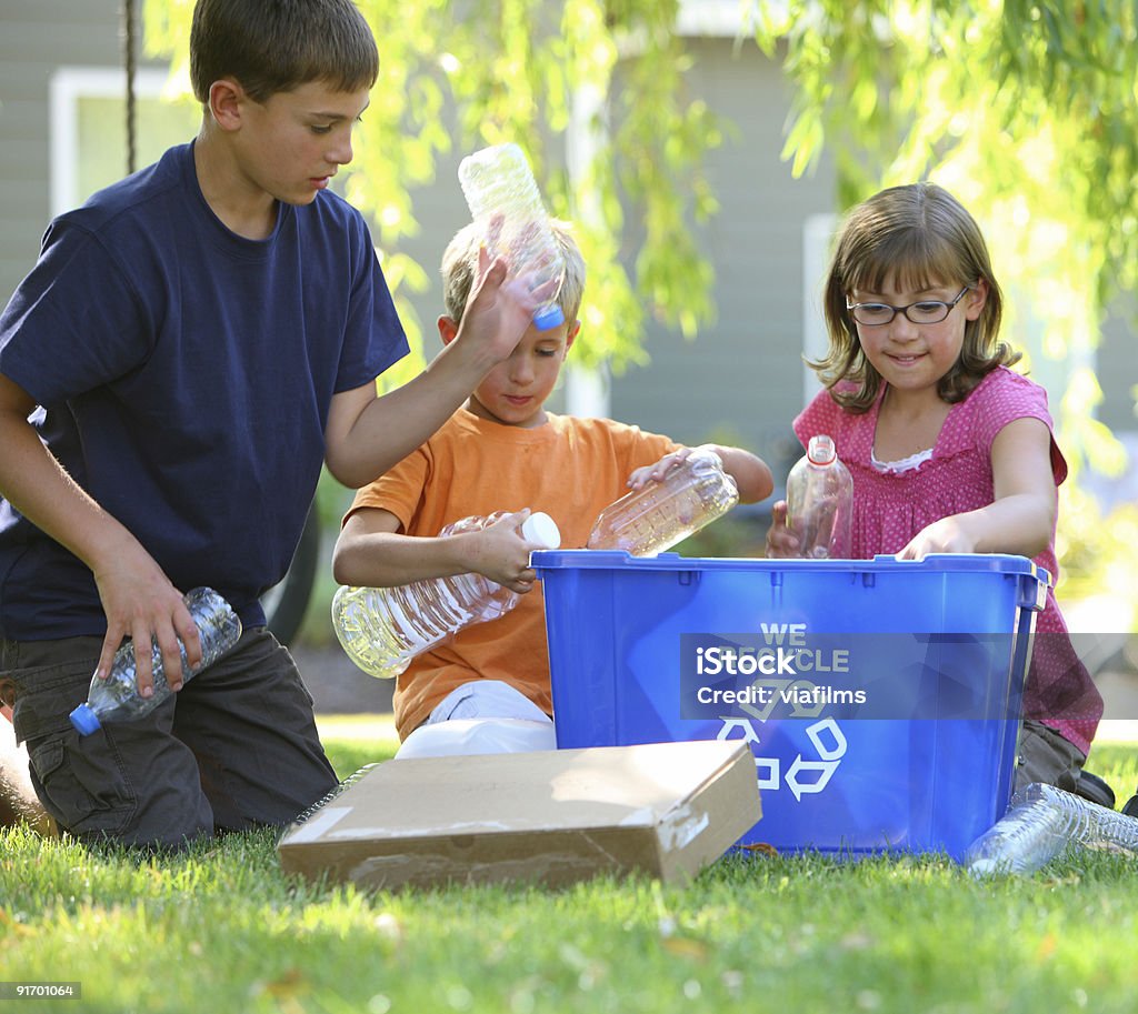 Kids filling recycle bin  Bottle Bank Stock Photo