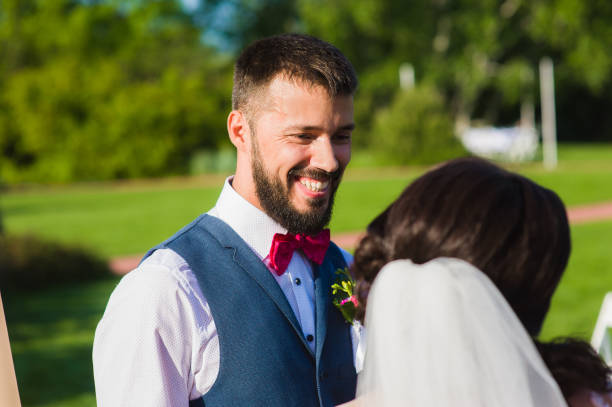 istock Groom smiling to his bride with a veil 917010882
