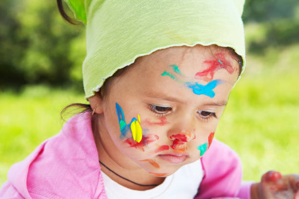 istock Little girl draws paints 917014052