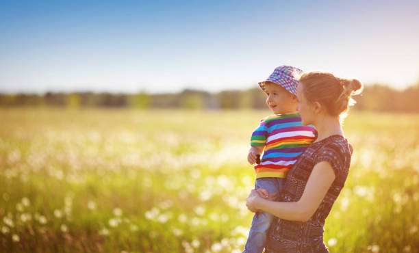 istock Young woman with a boy blowing bubbles 917014054