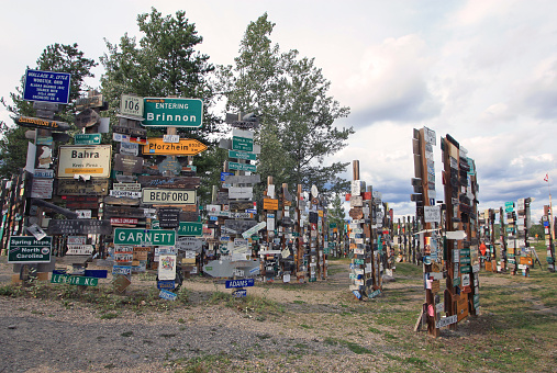 Watson Lake, Yukon, Canada - August 13, 2017: The Sign Post Forest is Watson Lake’s most famous attraction. Travelers from all over the world have been bringing signposts from their hometowns to the Sign Post Forest since 1942.
