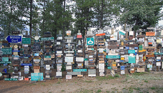 Watson Lake, Yukon, Canada - August 13, 2017: The Sign Post Forest is Watson Lake’s most famous attraction. Travelers from all over the world have been bringing signposts from their hometowns to the Sign Post Forest since 1942.