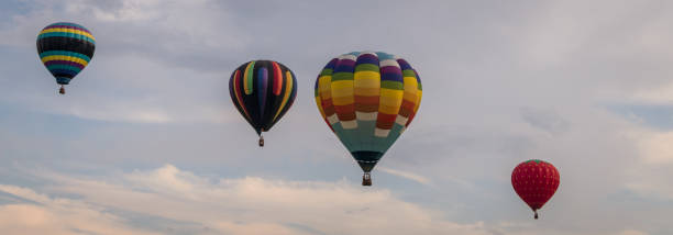 istock Colorful hot air balloons float through the sky on a summer evening 917017560