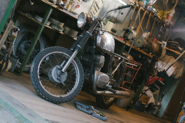 istock Old vintage motorcycle, which needs to be repaired, in the workshop, with set of tools 917020660