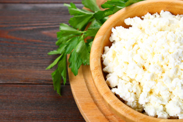 istock Home cottage cheese in a bowl on a wooden table. 917027282