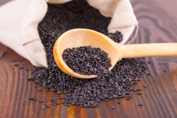 istock black sesame in spoon on wooden surface. 917027360