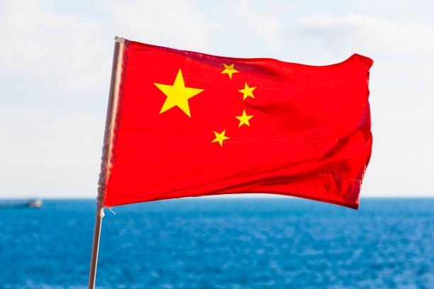 Chinese National Flag Against Blue sea. Chinese National Flag Against Blue sea fang xiang stock pictures, royalty-free photos & images