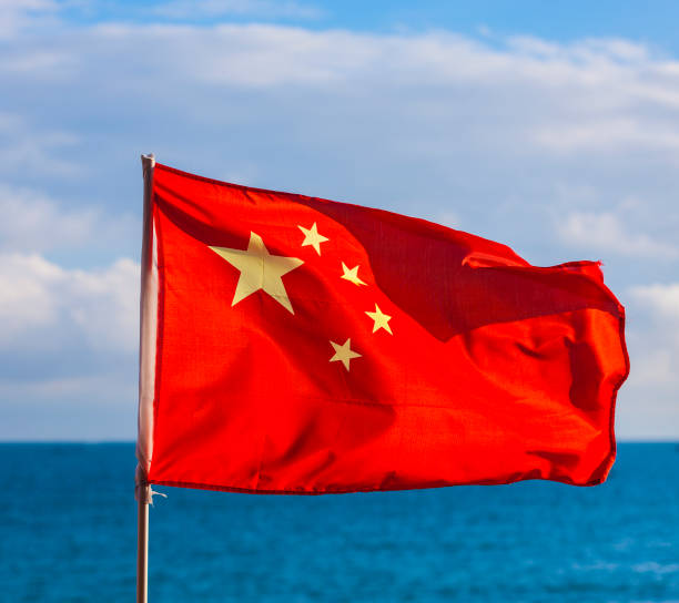 Chinese National Flag Against Blue sea. Chinese National Flag Against Blue sea fang xiang stock pictures, royalty-free photos & images