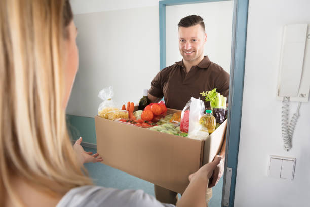 istock Delivery Man Holding Groceries 917033858