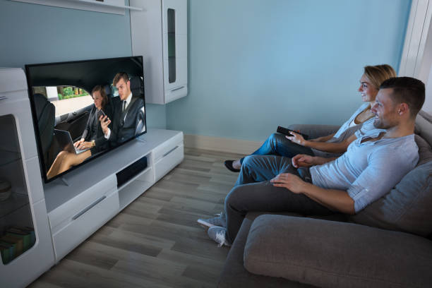 istock Couple Watching Television At Home 917033968