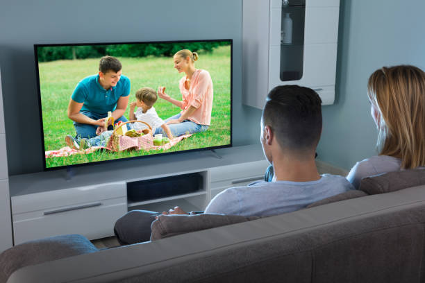 istock Couple Watching Video On Television 917033984
