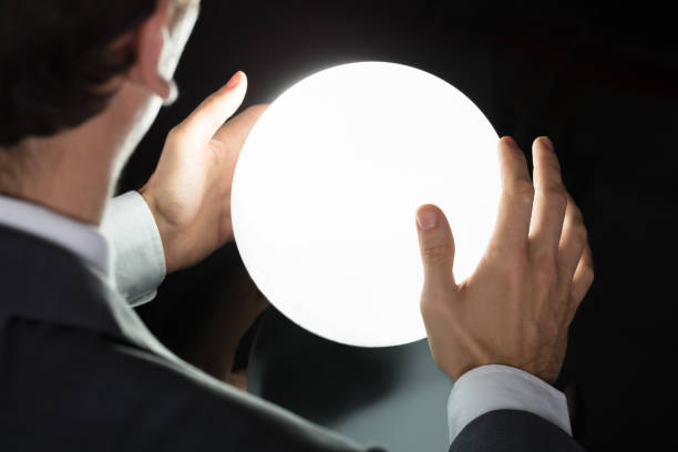 istock Businessman's Hand Predicting Future With Crystal Ball 917034192