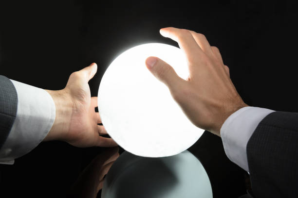 istock Businessman's Hand Predicting Future With Crystal Ball 917034196