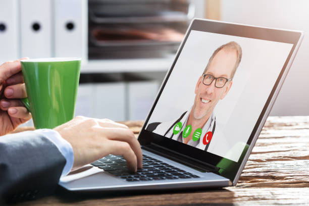 istock Person Video Conferencing With Doctor On Laptop 917034328