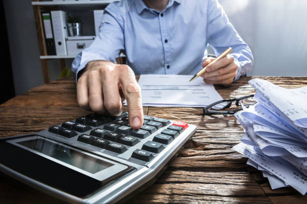 istock Businessperson Calculating Invoice With Calculator 917034492