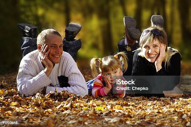 Happy Family In Autumn Park Stock Photo - Download Image Now - Activity, Adult, Autumn