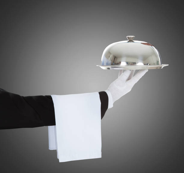 istock Waiter's Hand Holding Cloche And Tray 917037238