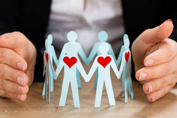 istock Hand Protecting Circle Of Paper Cut-out Figures 917037322
